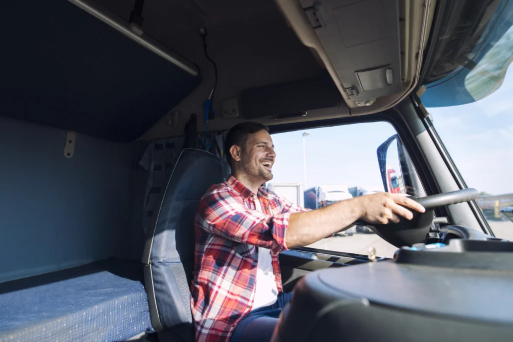 professional-middle-aged-truck-driver-casual-clothes-driving-truck-vehicle-delivering-cargo-destination-1030x687-1-1024x683